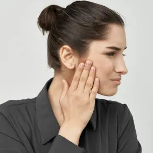 Young woman experiencing jaw and ear pain