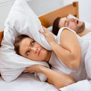 Snoring Man Sleeping With Apnea And Sleepless Woman