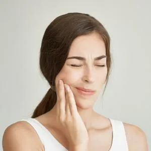 Young woman experiencing jaw and ear pain