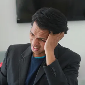 A man holding his ear in pain